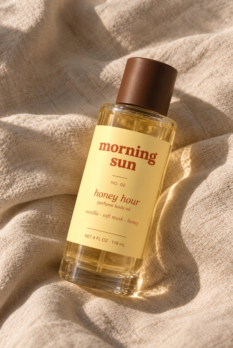 Morning Sun Honey Hour perfume body oil, no. 02, on linen in golden sunlight